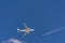 Two airplanes in the sky crossing paths at different flight travel altitudes