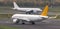 Two airplanes speeding at an airport runway