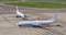 Two airplanes taxiing at the airport, on the steering track, and the gangplank.