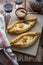 Two ajarian khachapuri, georgian bread with cheese and yolk