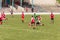 Two amateur football teams play on the field in