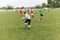 Two amateur football teams play on the field in