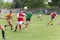 Two amateur football teams play on the field in