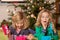 Two amazed girls with christmas presents