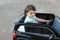 Two amazing girls ride in one big toy car on city street asphalt. Outdoor driving in a summer attraction for children