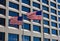 Two American Flags fly in the breeze in front of a building in Lower Manhattan, NYC