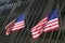 Two American flags in front of New York Stock Exchange on Wall Street, New York City, New York