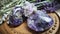 two amethysts sitting on top of a table next to lavender flowers