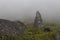 Two ancient indigenous monoliths in middle of a cloudy colombian countryside