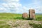 Two ancient menhirs with ribbons tied stand like guards in the endless steppe