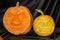 Two anthropoid faces carved from pumpkin