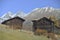 Two antique wooden houses from old village from Zermatt with Matterhorn peak in background