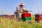 Two apiarists, beekeepers are harvesting honey, vintage