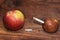 Two apples and a cigarette in wood background. smoke kills. No smok