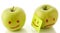 Two apples, smiling and crying on white