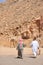 Two arab men and camel walking