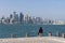 Two Arabian Middle Easter women Sitting on Corniche Broadway and Looking on the Doha Skyline View. Qatar, Middle East