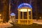 Two arbors with electric garlands in city park at winter