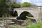Two arched stone bridge over River Swale Swaledale