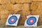 Two archery targets on straw background