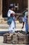 Two Arhuaco men dressed with their traditional clothes selling traditional bags in Cartagena de Indias