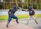 Two armed men lead a sword fight, a medieval fight, at a fun medieval tournament