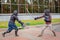 Two armed men lead a sword fight, a medieval fight, at a fun medieval tournament