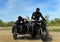 Two armed men riding a motorcycle