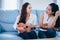 Two asia women are having fun playing ukulele and smiling at ho