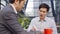 Two asian business associates meeting in outdoor coffee shop