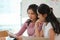 Two asian businesswomen focused reading a financial report paper