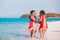 Two asian child girls holding hand each other and playing together on beach near the sea in summer vacation