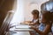 Two asian child girls traveling by an airplane and spending time by drawing and reading a book during the flight