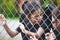 Two asian child girls wearing halloween costumes and makeup holding steel mesh and  having fun on Halloween celebration