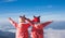 Two asian child girls wearing sweater and warm hat raise their arms looking at the beautiful mist and mountain with