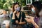 Two Asian female customer wearing protective mask talking at the cafe and drinking coffee together, new normal and social distanci