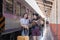 Two Asian female tourist friends are at the train station. Waiting for the train to travel to the provinces together on