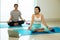 Two Asian female trainer trainee practise yoga pose Seated on blue mat