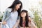 Two asian girl teen love together looking together and smile