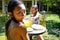 Two Asian Girls in Swimsuit Having Some Meals and Drinking Juice. Having Fun Together After Swimming Activities