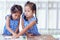 Two asian lilttle girls helping and trying to connect jigsaw