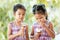 Two asian little child girls eating delicious icecream cone