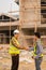 Two Asian male engineers shaking hands and working together Hope stands on the architectural construction