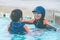 Two Asian in playing together in Water Aqua park pool