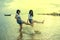 Two asian teenager relaxing and playing ons summer vacation sea beach