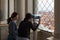Two asian tourist girls are looking on Piazza San Marco from the bell tower of St Mark`s Campanile Campanile di San