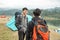 Two asian travelers standing near lake