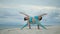 Two asian woman playing yoga pose on sea beach