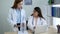 Two asian women doctors discuss meeting doctor`s office medical clinic using laptop consulting patient disease. Asian medical lab