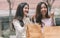 Two asian women doing window shopping together